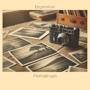 Vintage camera surrounded by black-and-white photographs on a wooden table. Photograph by Improline